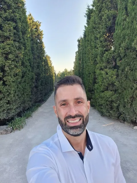 Tiago Balabuch smiling on a garden path.